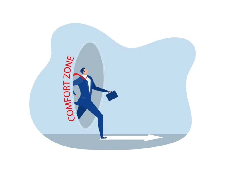 Businessman in a suit stepping out of a gray oval labeled 'Comfort Zone' into a light blue background, holding a briefcase.
