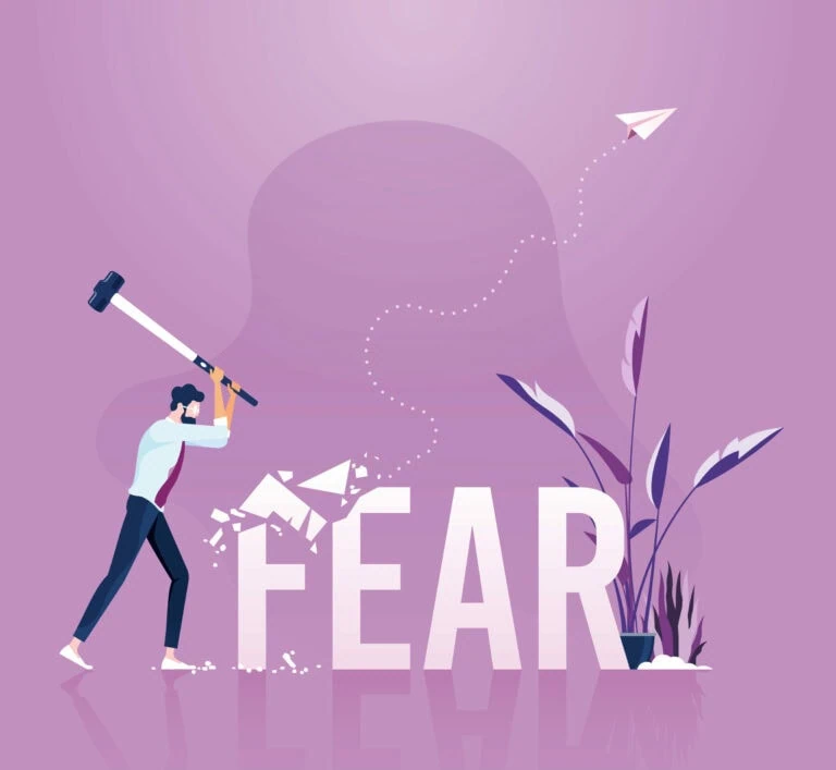 Businessman holding sledgehammer hitting fear word