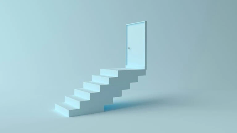 A set of white stairs leading to a closed door on a light blue background, symbolizing progress and transition.