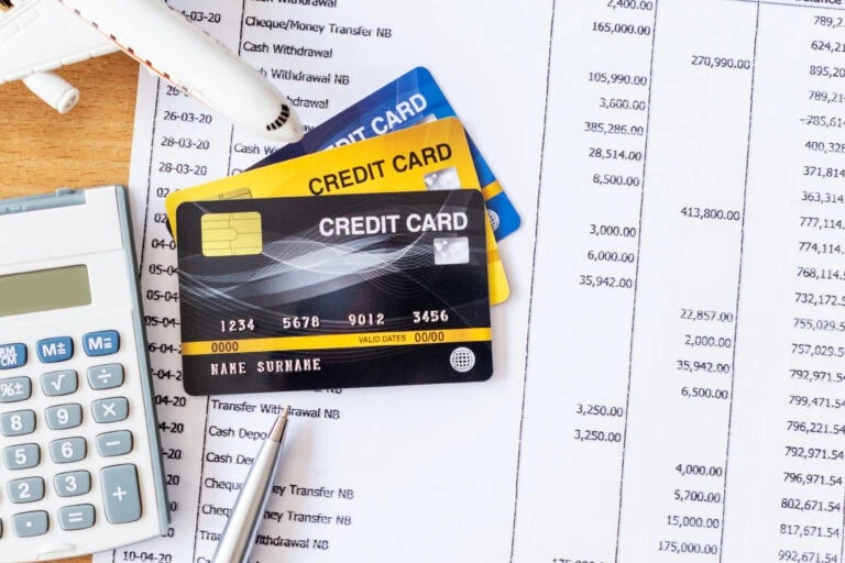 airplane model and calculator on bank statement and credit
