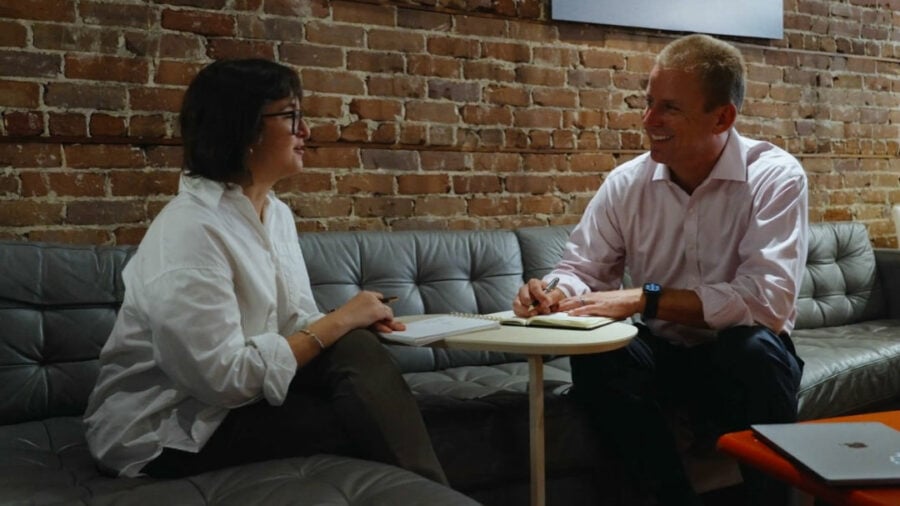 Kevin and a client sitting down and talking to each other.