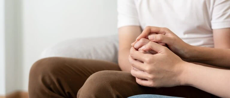 couple holding hands for support