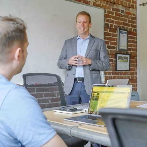 Kevin talking in front of a sales team.