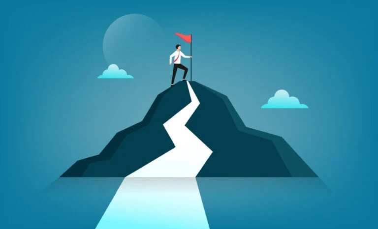 businessman holding a flag on top of a mountain
